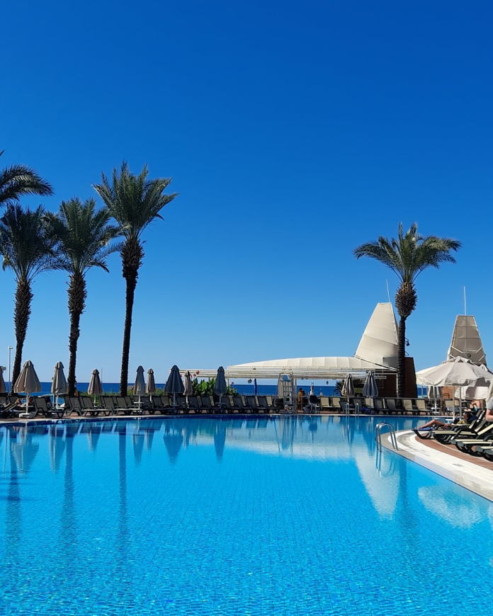 A hotel pool with a sea view