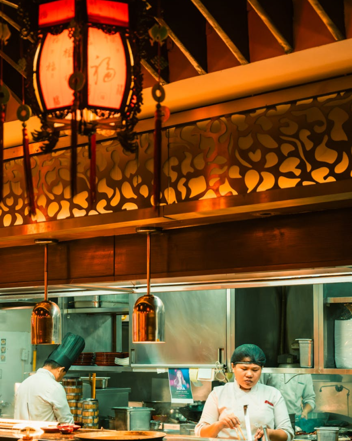 A chef in the kitchen preparing a refined dish
