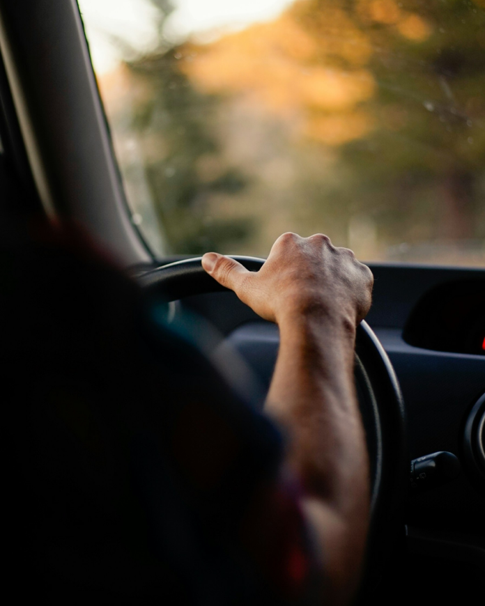 Close-up of a taxi driver's hands on the steering wheel
