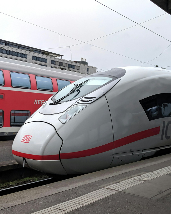 A high-speed train waiting at the station platform